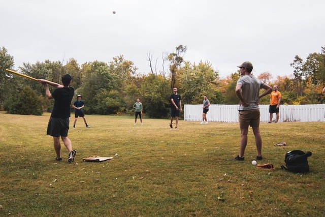 People playing baseball on grass